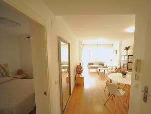a bedroom with a bed and a living room with a table at LA CURVA Orange Costa in Benicàssim