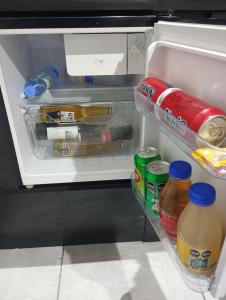 an open refrigerator filled with food and drinks at Alojamiento el descanso in Ezeiza