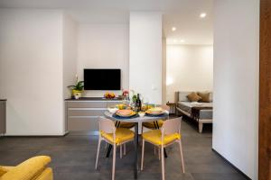 a living room with a table and chairs and a couch at Tra Mare & Trulli 2 in Fasano