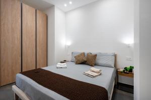 a bedroom with a bed with two towels on it at Tra Mare & Trulli 2 in Fasano