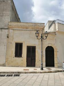 a building with two doors and a street light at A casa di Marisa in Casamassella