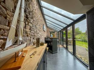 a bathroom with a sink and a stone wall at Gîte de charme in Paimpol