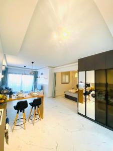 a kitchen and living room with a counter and chairs at Caesar Resort Apartments Marcellus 51 in Iskele +68 photos