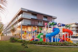 a playground in front of a apartment building at Porto Alto Resort ap 213 in Cupe