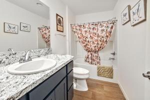 a bathroom with a sink and a toilet at King Sized Comfort in The Village of Deluna in The Villages +15 photos