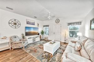 a living room with a couch and a tv at King Sized Comfort in The Village of Deluna in The Villages