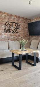 a coffee table in a living room with a couch at JAWORNICA HOUSE domek z pięknym widokiem in Targanice