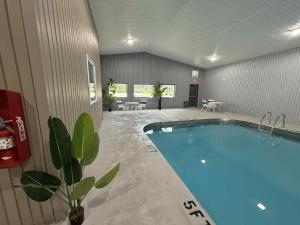 a large swimming pool in a large room with at Super 8 by Wyndham Gallipolis Pt Pleasant Area in Gallipolis