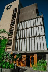 a building with a clock on the side of it at Get Sense Beira Mar in João Pessoa