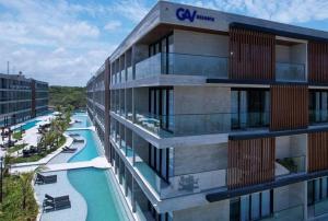 a building with a swimming pool next to a resort at Porto Alto Resort ap 213 in Cupe