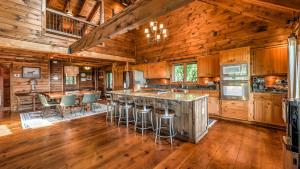 a kitchen with wooden cabinets and a bar with stools at Ridge Top Lodge in Blue Ridge