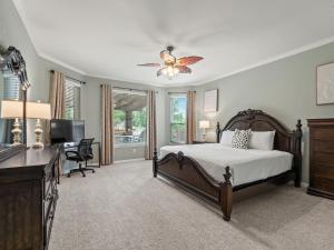 a bedroom with a bed and a ceiling fan at The Sapphire Sanctuary with Pool in Allen +58 photos