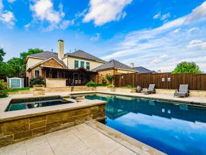 a swimming pool in a backyard with a house at The Sapphire Sanctuary with Pool in Allen