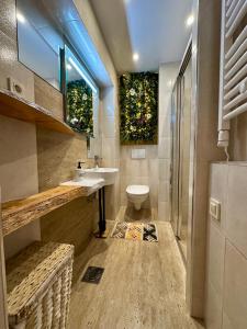 a bathroom with a toilet and a sink and a window at Sea View Budva in Budva