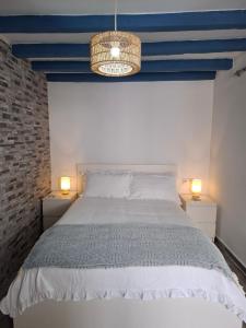 a bedroom with a bed with a blue ceiling at La casita de Paco in Barbate