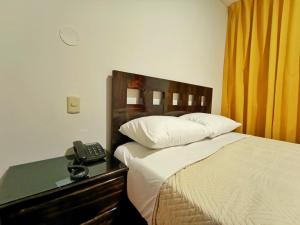 Ένα ή περισσότερα κρεβάτια σε δωμάτιο στο Hostal Atacama +1 φωτογραφίες