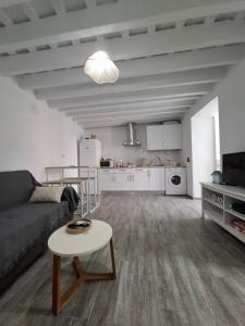 a living room with a couch and a table at La casita de Paco in Barbate