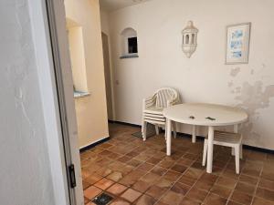 a room with a table and two chairs and a table at Luxury apartment puerto sherry in El Puerto de Santa María