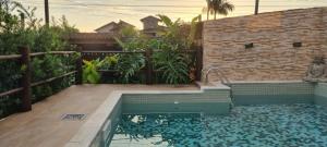 ein Swimmingpool im Hinterhof eines Hauses in der Unterkunft Chalé Vovó Zezé in Bertioga