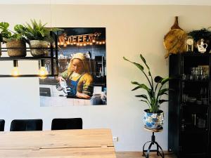a dining room with a picture hanging on the wall at House 'n Cheese - Alkmaar in Alkmaar