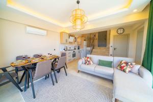 a kitchen and living room with a couch and a table at villa vista çukurbağ in Cukurbag +4 photos