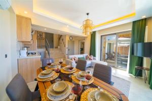 a living room with a table with dishes on it at villa vista çukurbağ in Cukurbag