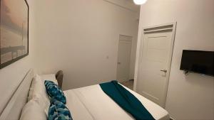 a small bedroom with a bed and a tv at Hotel Boutique Brisas Colonial in Santo Domingo +71 photos