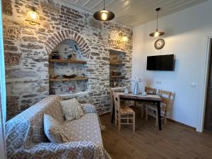 a living room with a couch and a table at Filipa Gardens in Limenas