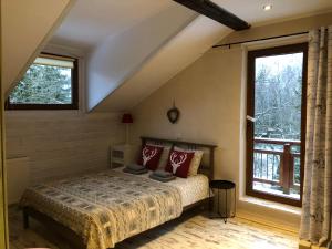 a bedroom with a bed and a large window at Willa Avita in Karpacz
