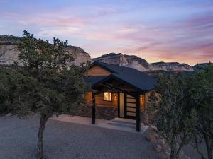 a cabin with a view of the canyon at sunset at Desert Canyon Casita Near Zion Hot Tub Views in Orderville
