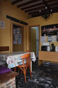 a room with a table and a table and a chair at Albergue El Caserón de Vidiago in Vidiago