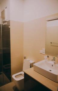 a bathroom with a white toilet and a sink at Luxury style room in Ghaziabad