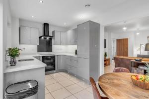 a kitchen with a table and a dining room at 2 bedroom house NE Norwich in Norwich