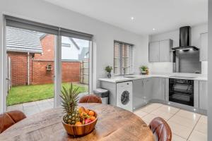 a kitchen with a table with a bowl of fruit on it at 2 bedroom house NE Norwich in Norwich