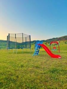 two playground equipment in a field of grass at Eternum Glamping in Žabljak