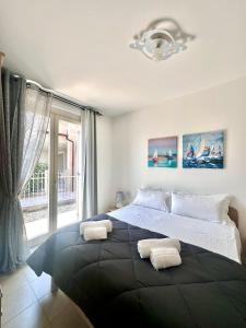 a bedroom with a large bed with two towels on it at Quadrivium Apartments in Castelnuovo del Garda