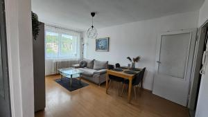 a living room with a couch and a table at Apartament RYŚ Polanica Zdrój in Polanica-Zdrój