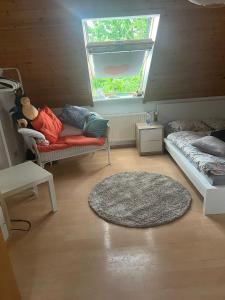 a small room with a bed and a window at Zentral im Grünen in Dortmund