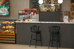 two bar stools sitting at a counter in a store at Batumi Skynest in Batumi
