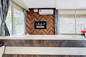 a dining room with a wooden wall and a window at Super Collection O Bhanugudi Junction Kakinada Formerly Stay Inn Luxury in Kākināda