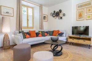 a living room with a couch and a tv at La Roseraie - Disney 30 minutes in Saint-Augustin