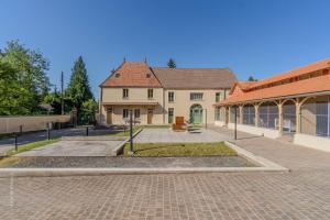 a house with a brick driveway in front of a building at La Roseraie - Disney 30 minutes in Saint-Augustin
