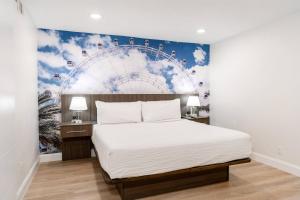 a bedroom with a large bed with a mural on the wall at The Fold Hotels Orlando in Orlando +11 photos