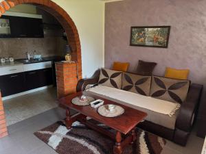 a living room with a couch and a table at Kuća na obali Save in Obrenovac