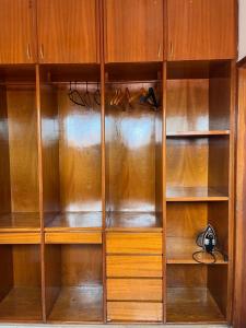 a wooden closet with wooden shelves at Ampla Casa Duplex com 4 suítes in Teresina
