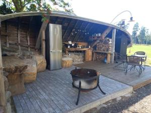 a large outdoor patio with a refrigerator and a kitchen at Arakaoja saunamaja in Nepste +6 photos