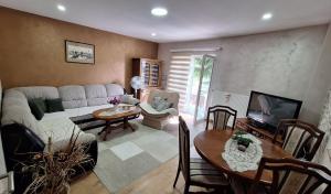 a living room with a couch and a table at Apartman Nani in Bihać