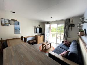 a living room with a couch and a table at Résidence Belle Dune - maeva Home - Appartement chaleureux 2 pièces 4 personnes - Prestige MAE-8313 in Fort-Mahon-Plage +13 photos