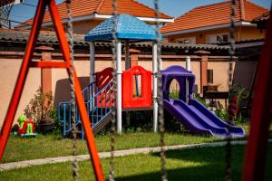 a yard with a playground with a slide at Casa Soarelui in 2 Mai