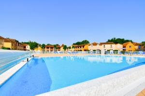a large swimming pool with blue water in a resort at La résidence du Lac - maeva Home - Maison 3 pièces 6 personnes - Prestige MAE-1083 in Monflanquin +18 photos